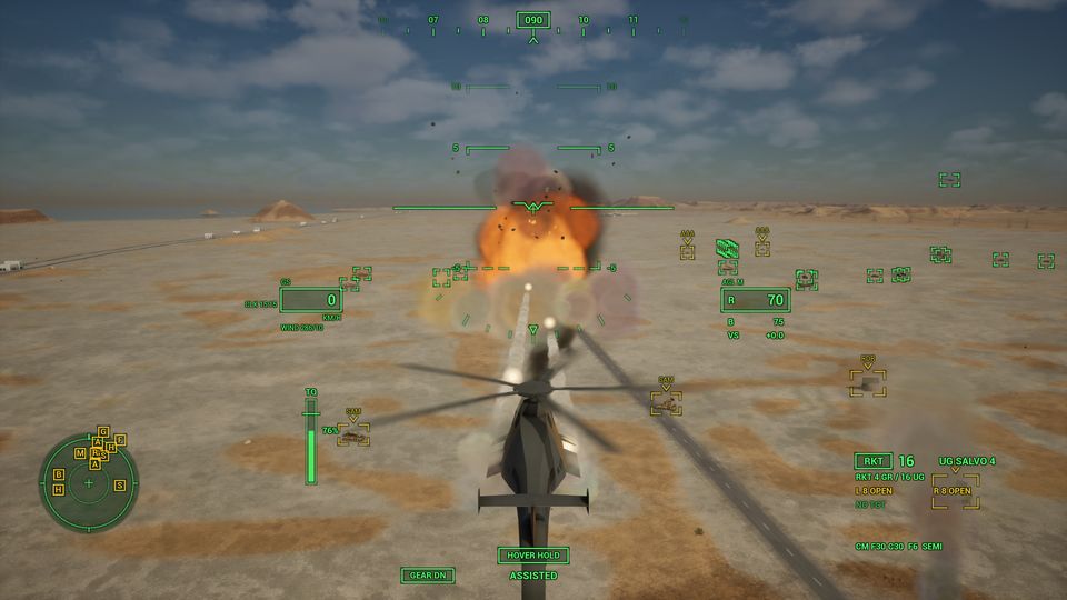 The helicopter in chase view as a ground target explodes ahead of it in the desert